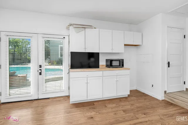 a view of a house with swimming pool and sitting area