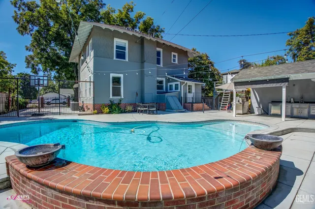 a view of a patio with a table and chairs under an umbrella