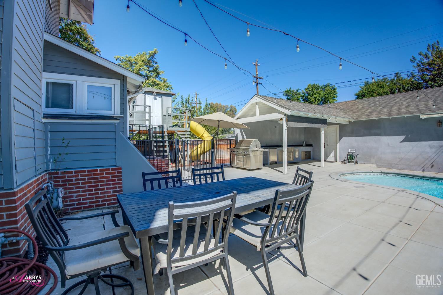Undisclosed Address Bakersfield, CA 93301 - Photo 50 of 58 a view of a patio with table and chairs with wooden floor