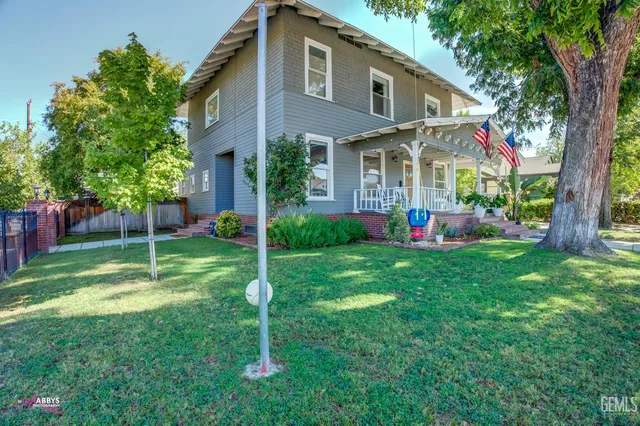a front view of house with yard and outdoor seating
