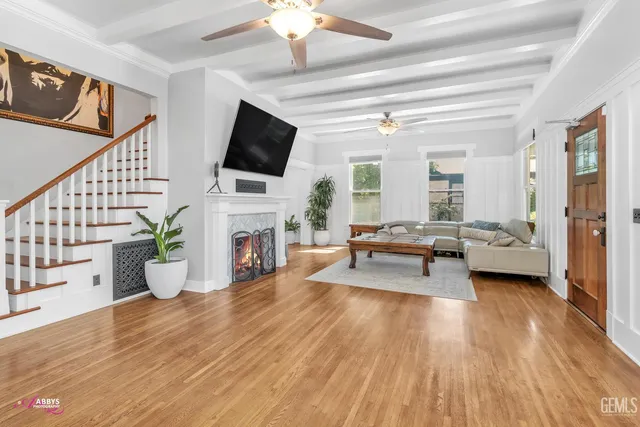 a living room with furniture a fireplace and a flat screen tv