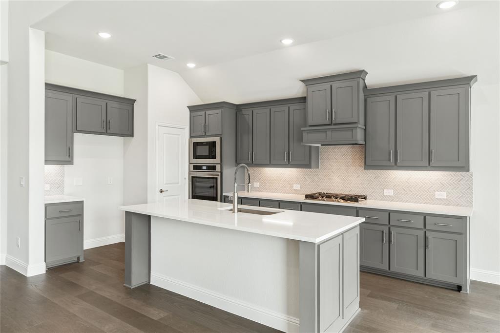3002 Wild River Road Melissa, TX 75454 - Photo 15 of 36 a kitchen with kitchen island a sink stainless steel appliances and cabinets