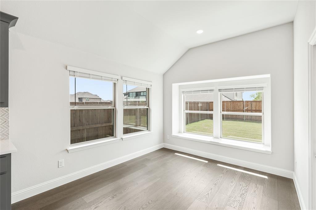 3002 Wild River Road Melissa, TX 75454 - Photo 16 of 36 an empty room with wooden floor and windows