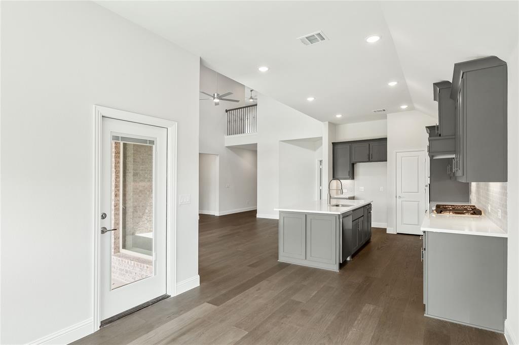 3002 Wild River Road Melissa, TX 75454 - Photo 17 of 36 a view of kitchen with stainless steel appliances kitchen island wooden floors and living room view