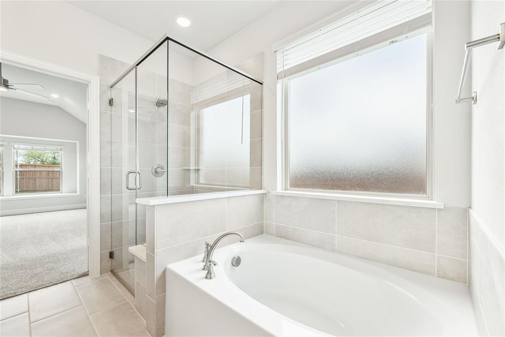 3002 Wild River Road Melissa, TX 75454 - Photo 22 of 36 a bathroom with a bathtub and a shower