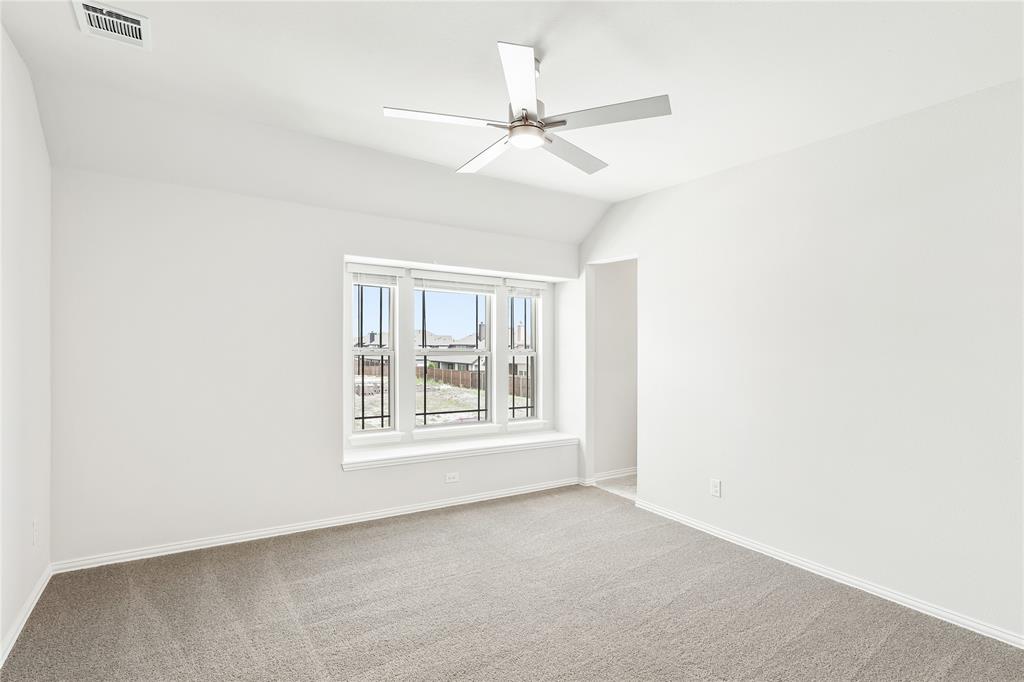 3002 Wild River Road Melissa, TX 75454 - Photo 29 of 36 an empty room with a ceiling fan and windows