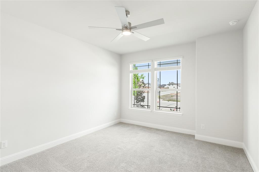 3002 Wild River Road Melissa, TX 75454 - Photo 6 of 36 an empty room with a ceiling fan and window