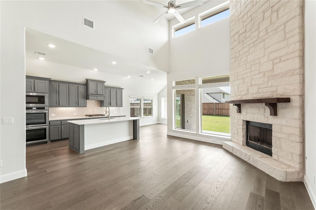 3002 Wild River Road Melissa, TX 75454 - Photo 10 of 36 a large kitchen with a large counter top stainless steel appliances and wooden floor
