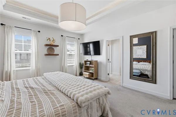 a bedroom with a bed and a television