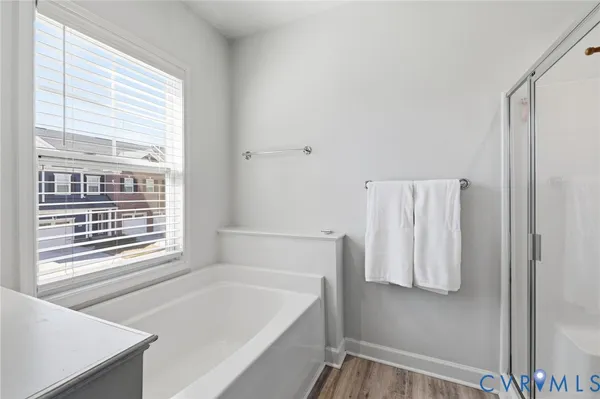 a bathroom with a bathtub and a window