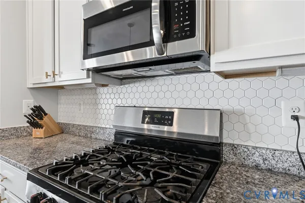 a kitchen with a stove and a microwave