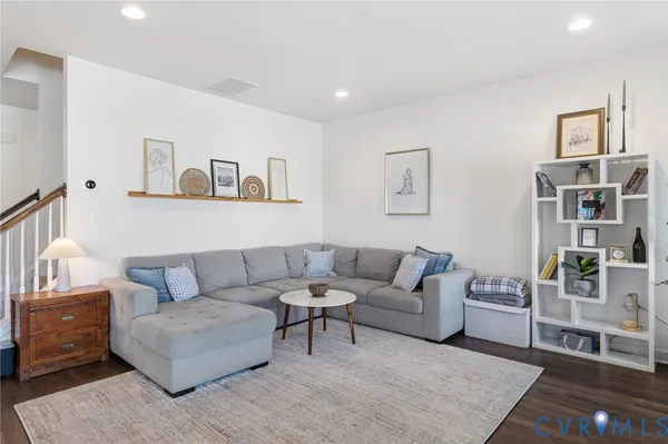 a living room with furniture and painting on the wall