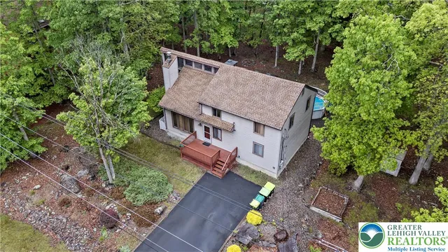 an aerial view of a house with a big yard