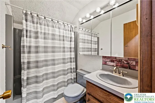 a view of a chairs and table in the backyard