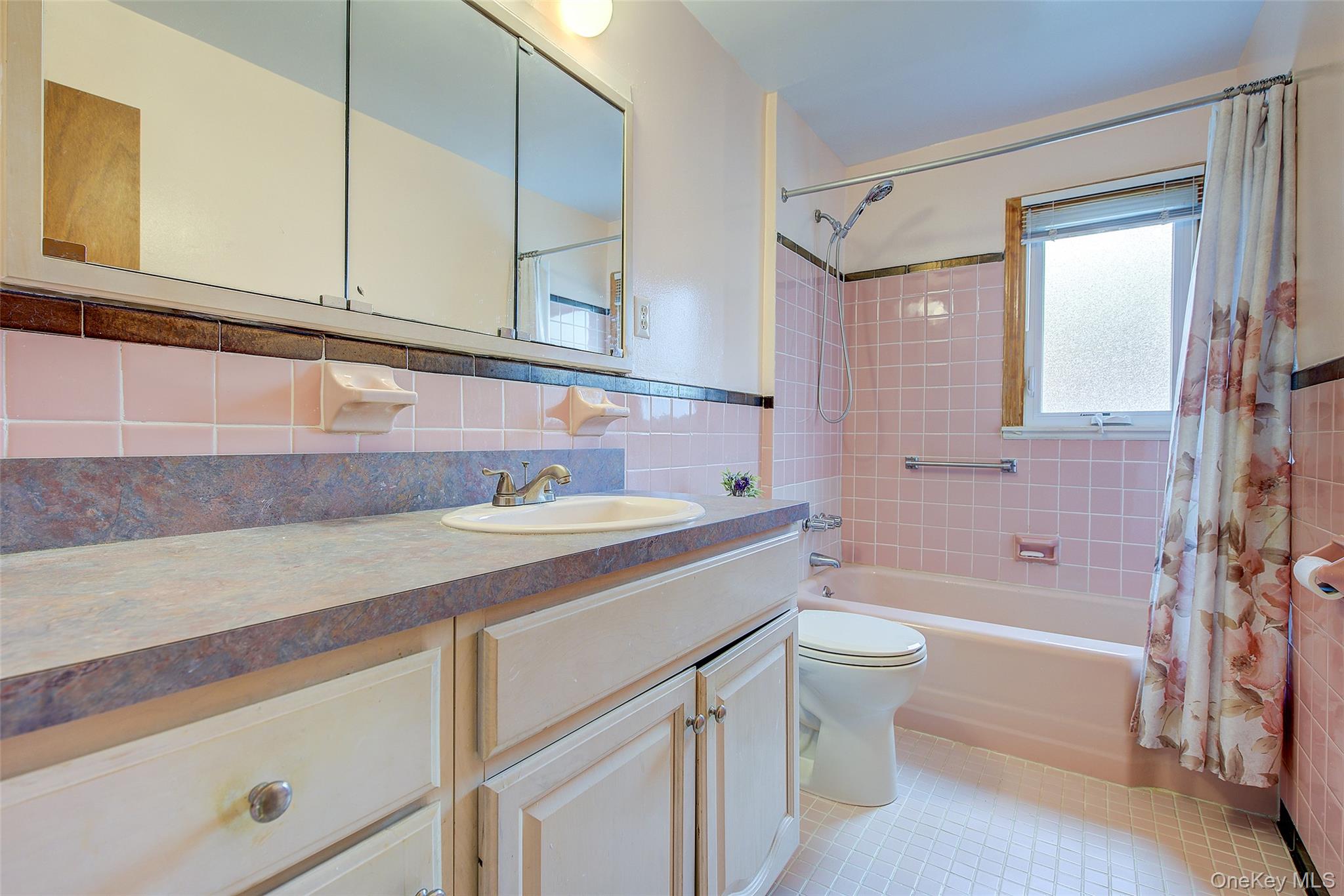 163-02 45th Avenue Queens, NY 11358 - Photo 24 of 35 Full bathroom featuring vanity, shower / tub combo with curtain, tile walls, light tile patterned flooring, and tasteful backsplash