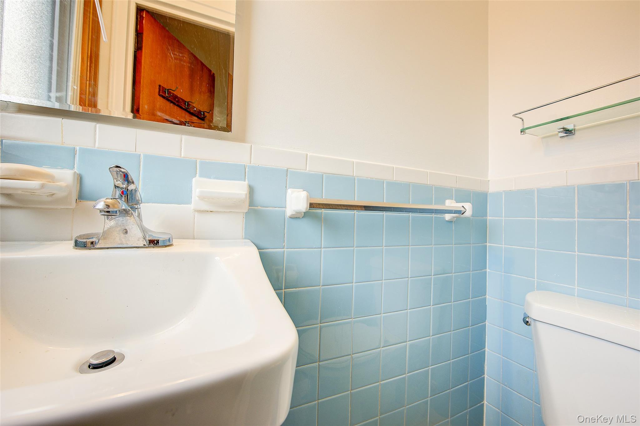 163-02 45th Avenue Queens, NY 11358 - Photo 28 of 35 Half bathroom with tile walls and wainscoting
