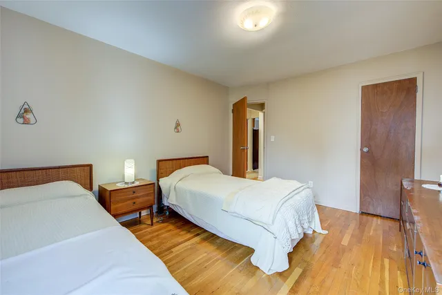 a bedroom with a bed and a large mirror