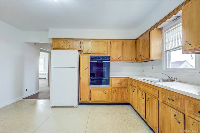 a kitchen with stainless steel appliances granite countertop a refrigerator a sink and dishwasher