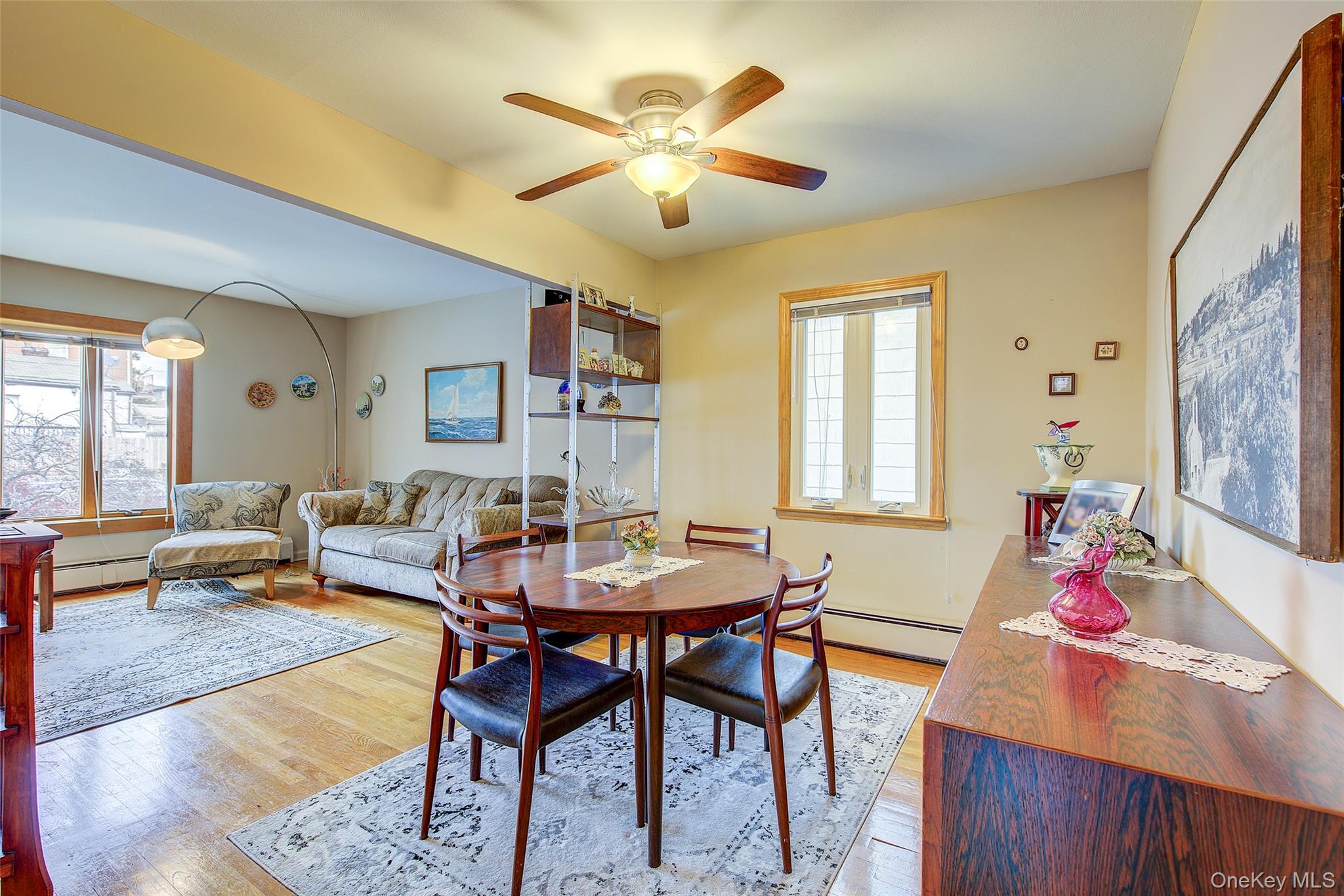 163-02 45th Avenue Queens, NY 11358 - Photo 5 of 35 Dining room featuring light wood finished floors, baseboard heating, and a ceiling fan