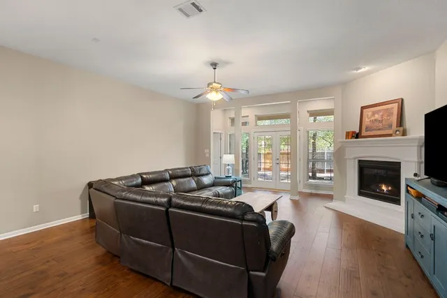 a living room with furniture fireplace and a large window
