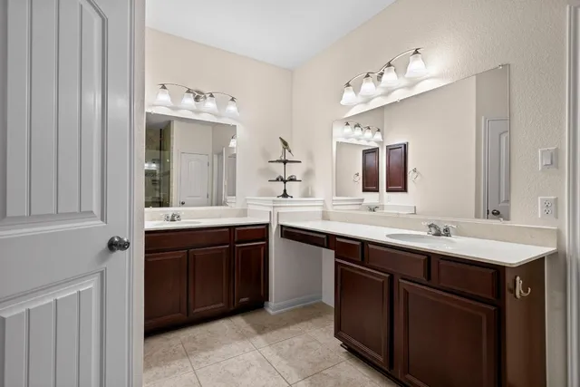 a bathroom with a double vanity sink and a mirror