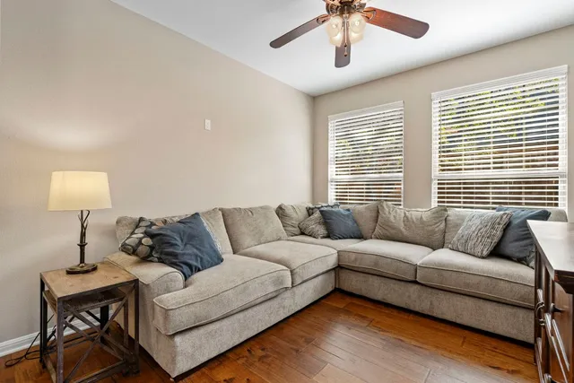 a living room with furniture and a lamp