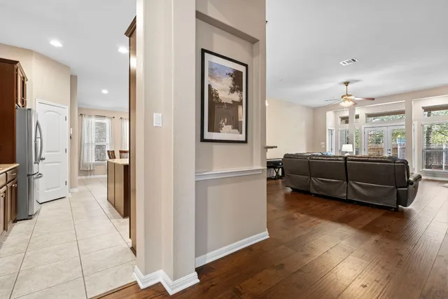 a living room with furniture and a refrigerator