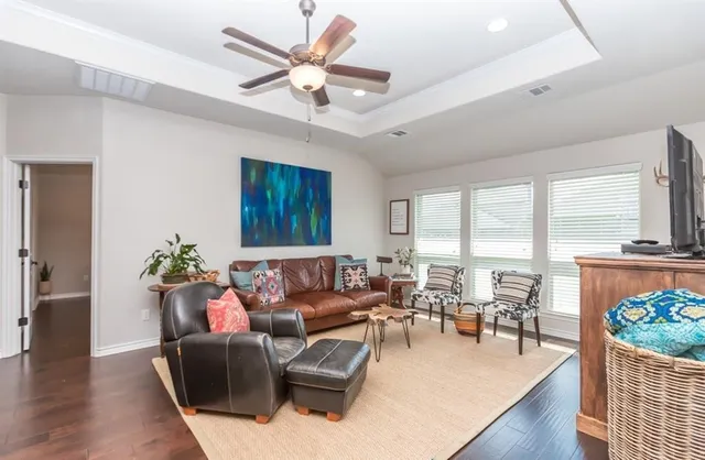 a living room with furniture and wooden floor