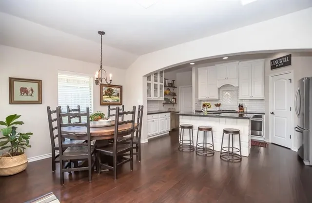 a dining room with furniture and wooden floor