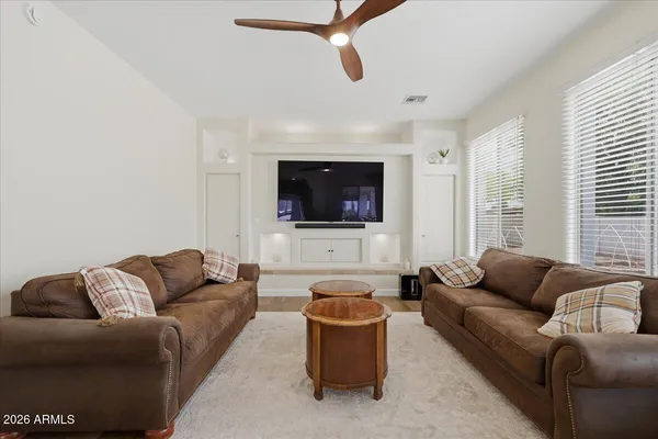 a living room with furniture and wooden floor