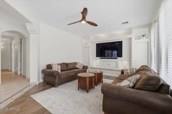 a living room with furniture and wooden floor