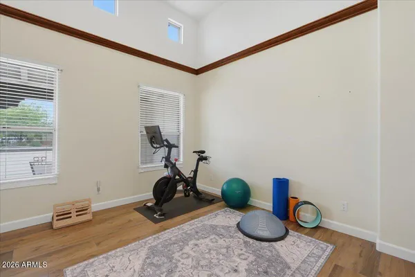 a large white kitchen with a stove a sink a window and a rug