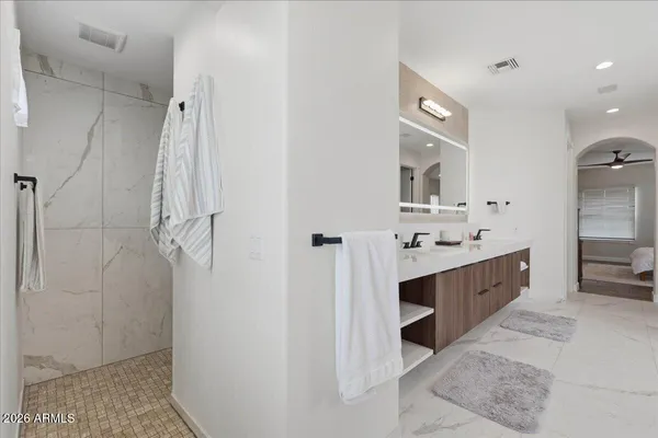 a bathroom with a granite countertop sink toilet and a mirror