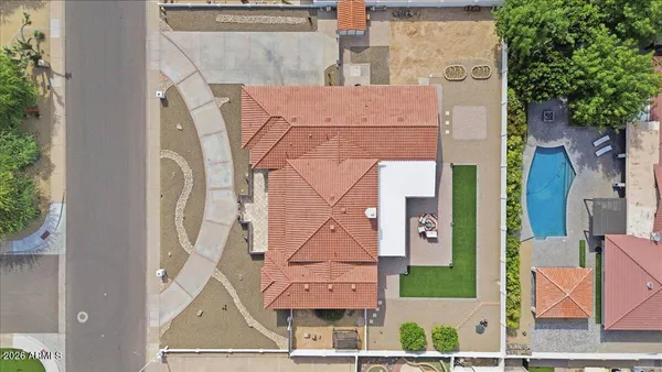 an aerial view of a house with a yard
