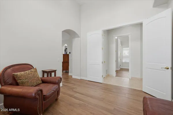 a living room with furniture and wooden floor