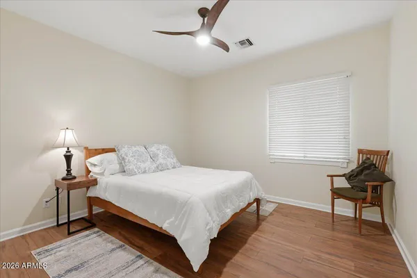a view of an empty room with a floor to ceiling window next to a yard