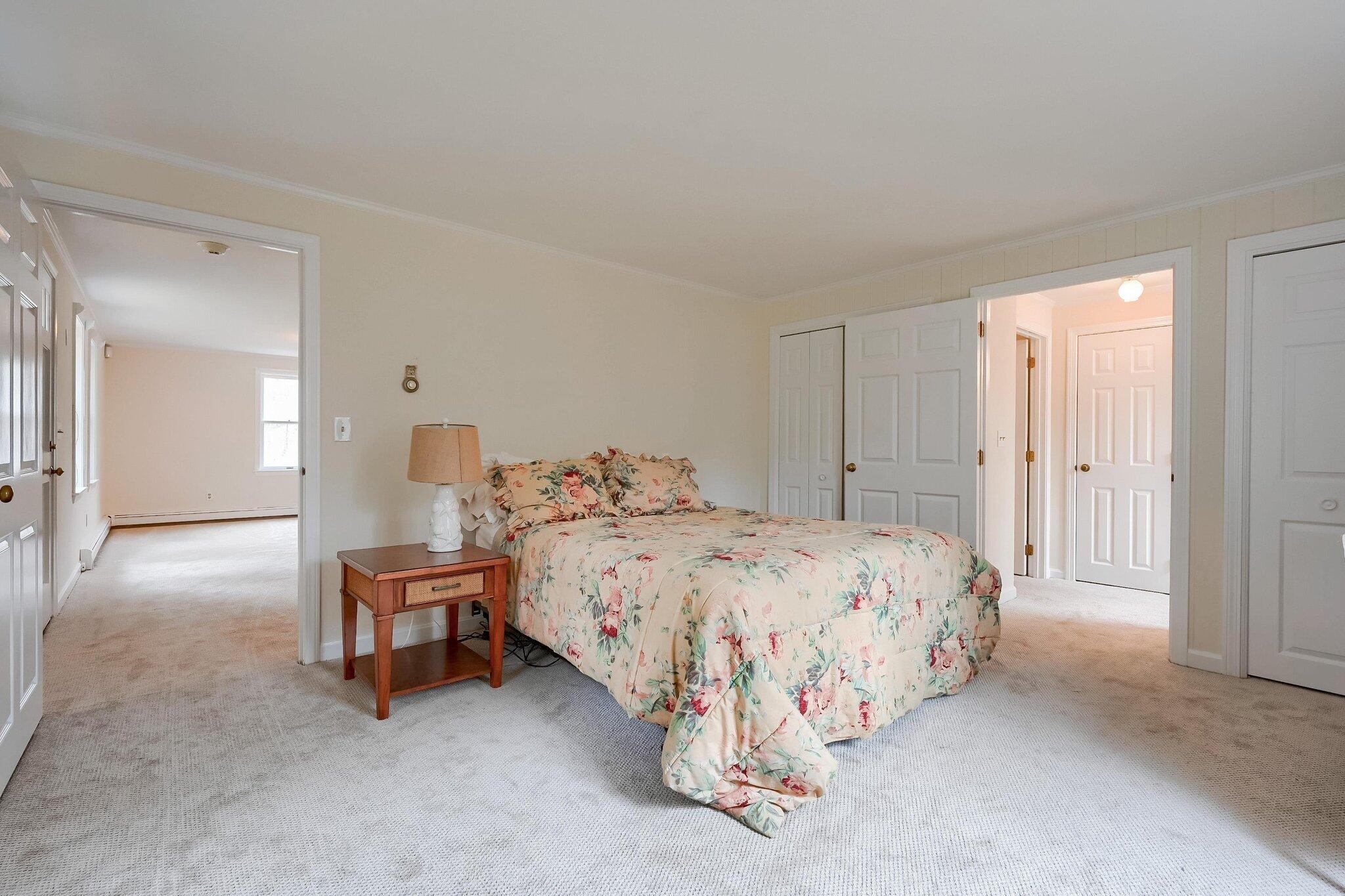 40 Barley Neck Road Orleans, MA 02653 - Photo 30 of 51 a bedroom with bed and a chandelier