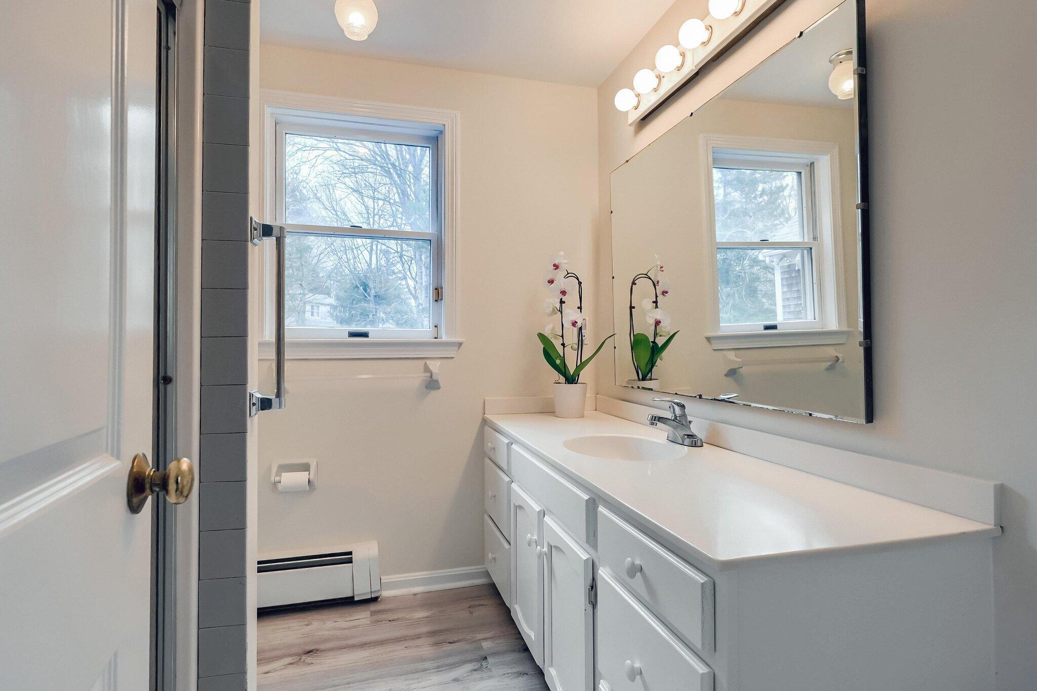 40 Barley Neck Road Orleans, MA 02653 - Photo 33 of 51 a bathroom with a sink a mirror and a window