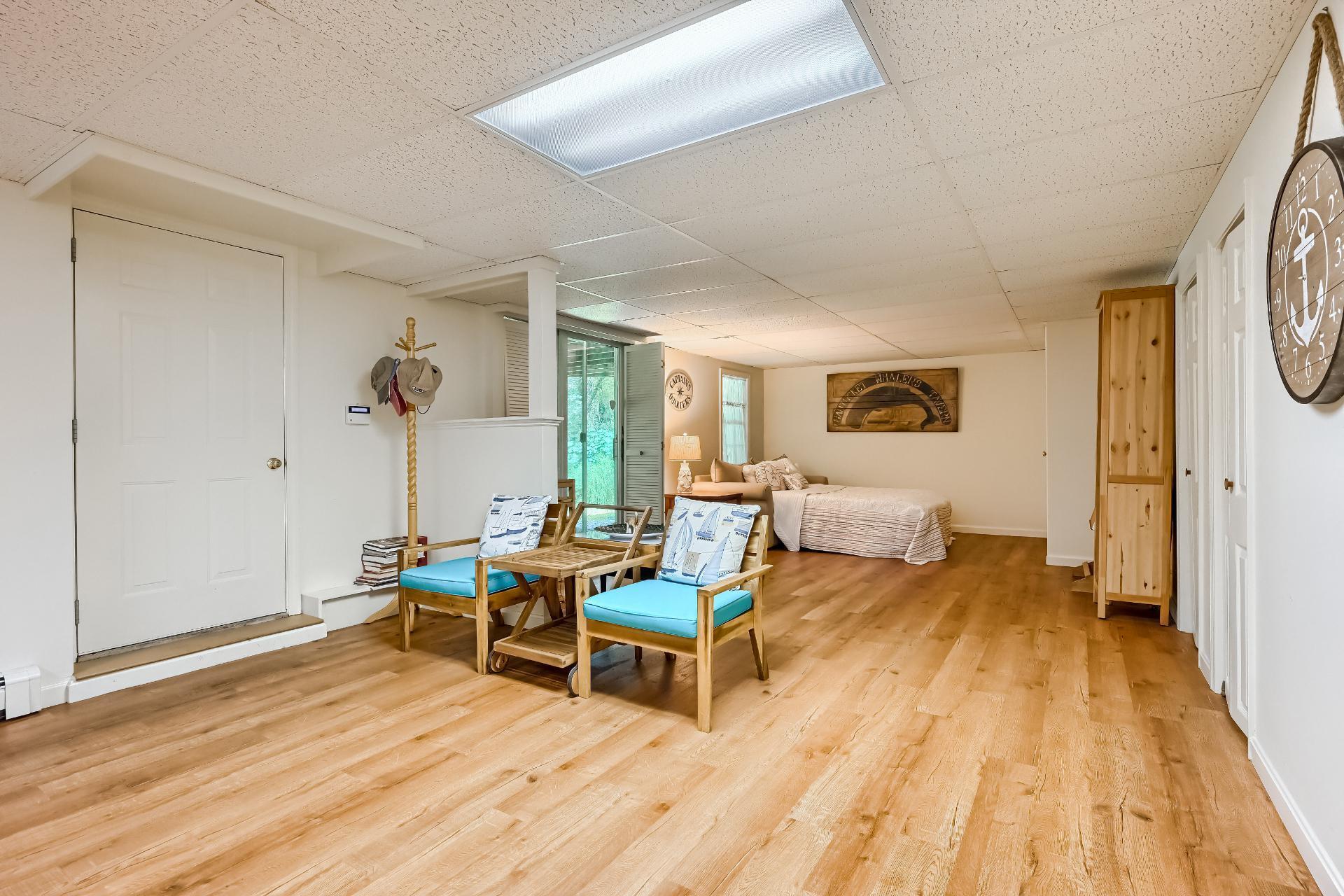 40 Barley Neck Road Orleans, MA 02653 - Photo 35 of 51 a living room with furniture and a wooden floor