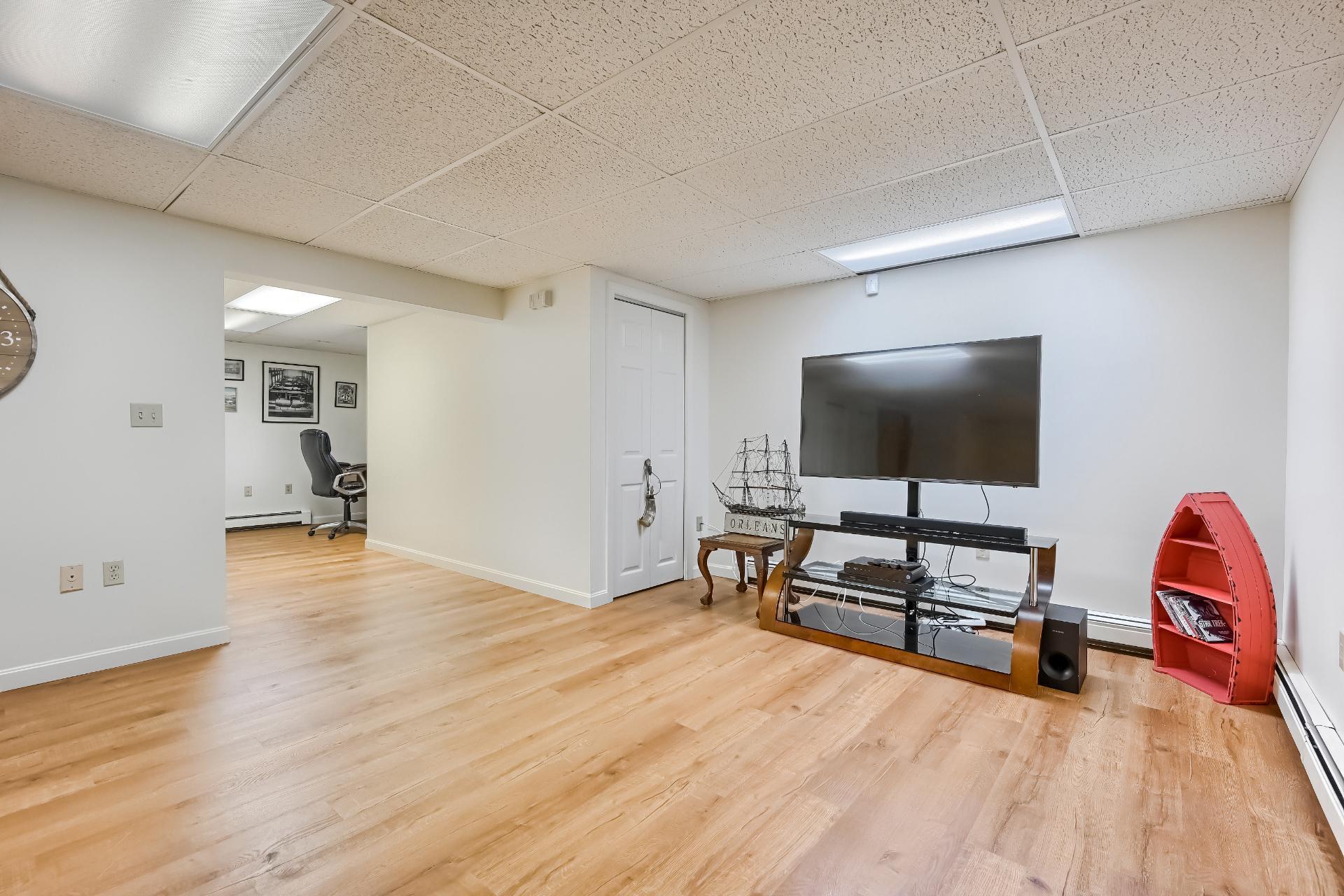40 Barley Neck Road Orleans, MA 02653 - Photo 36 of 51 a living room with furniture and a flat screen tv