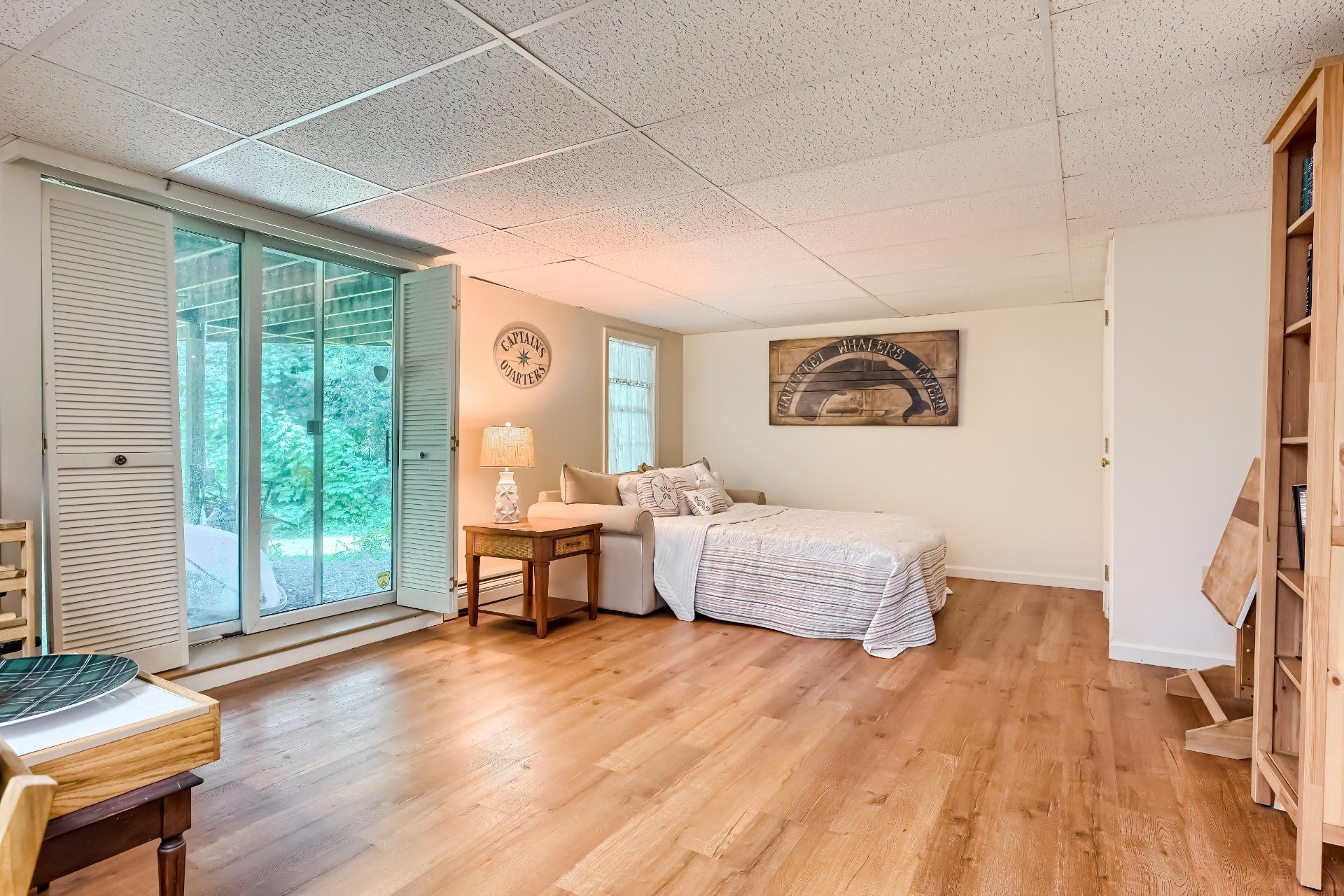40 Barley Neck Road Orleans, MA 02653 - Photo 37 of 51 a spacious bedroom with a large bed and a couch