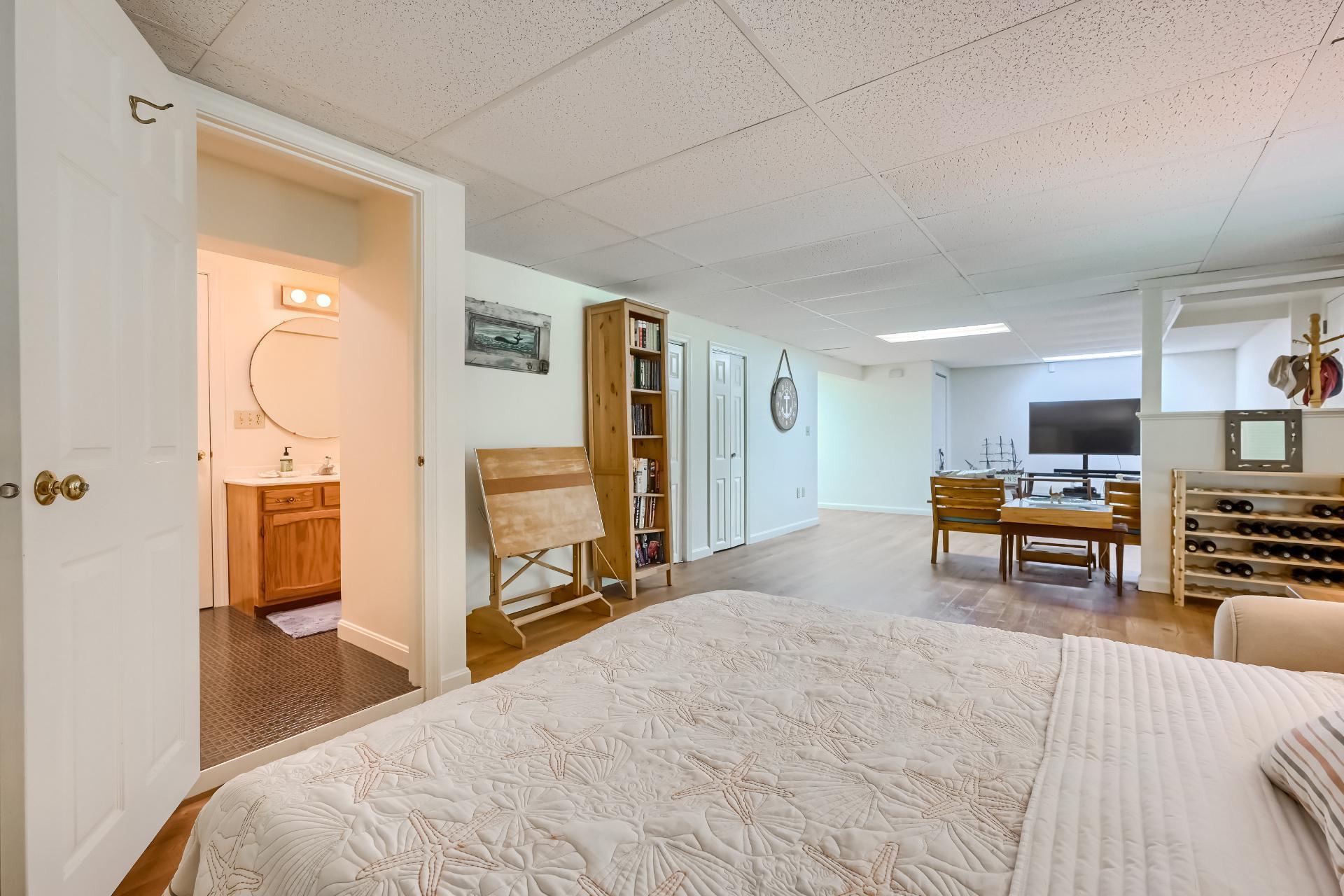 40 Barley Neck Road Orleans, MA 02653 - Photo 39 of 51 a bedroom with furniture and a mirror