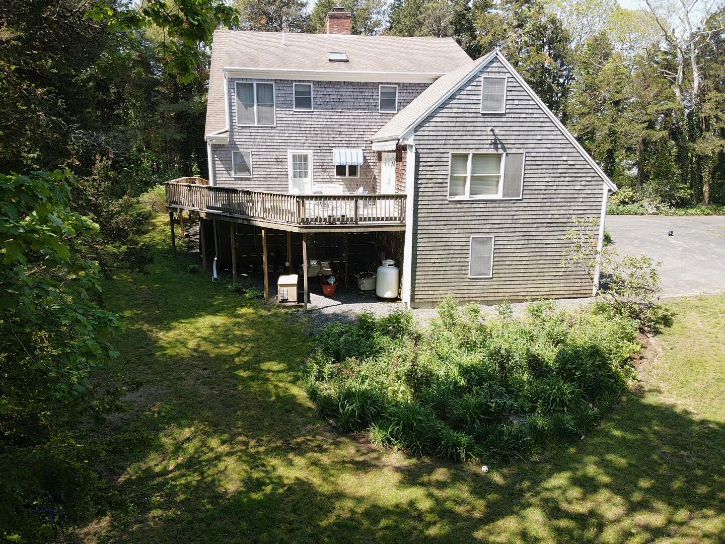 40 Barley Neck Road Orleans, MA 02653 - Photo 50 of 51 a view of a house with brick walls and a yard with plants
