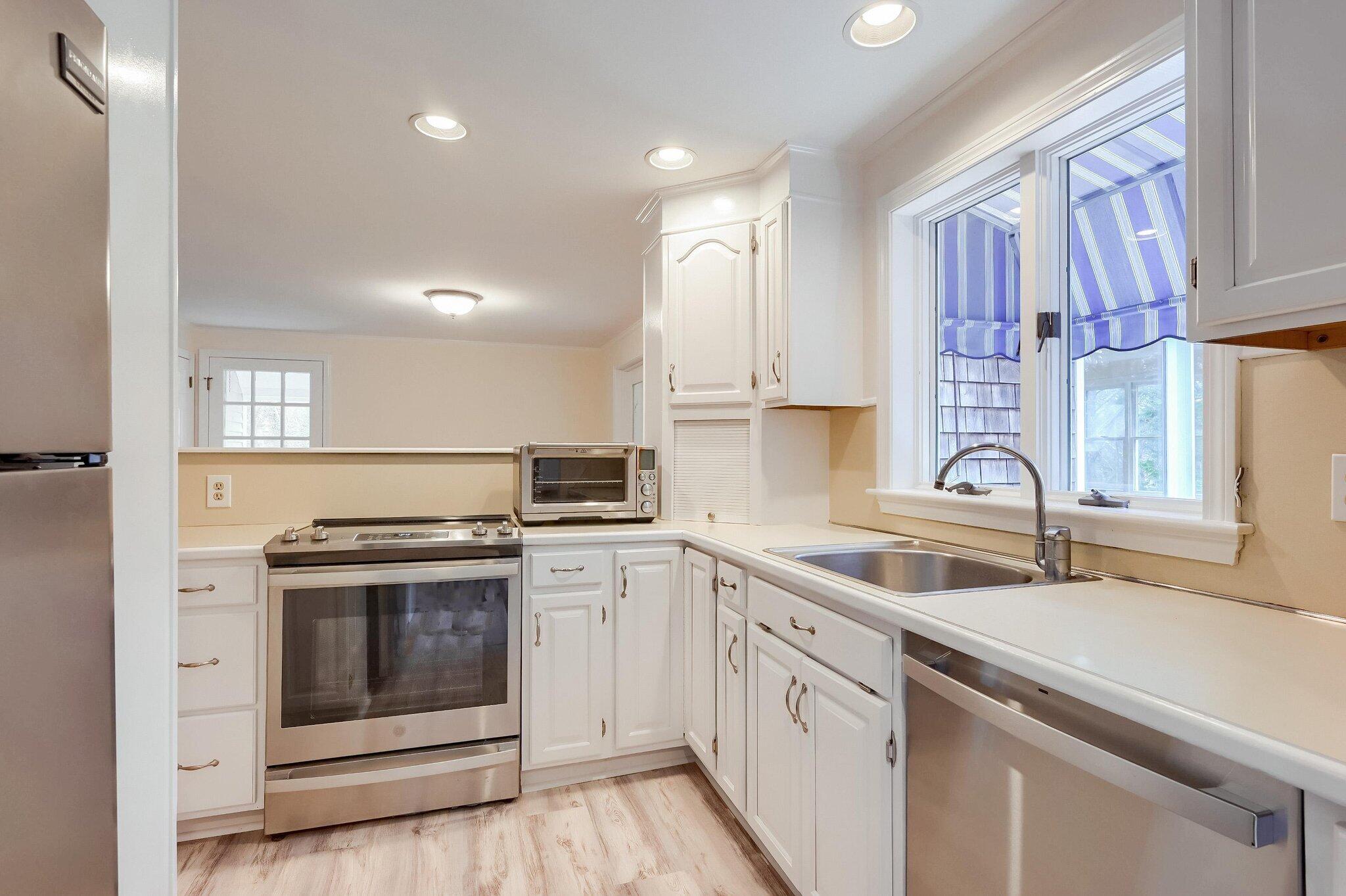 40 Barley Neck Road Orleans, MA 02653 - Photo 7 of 51 a kitchen with a sink stove and cabinets