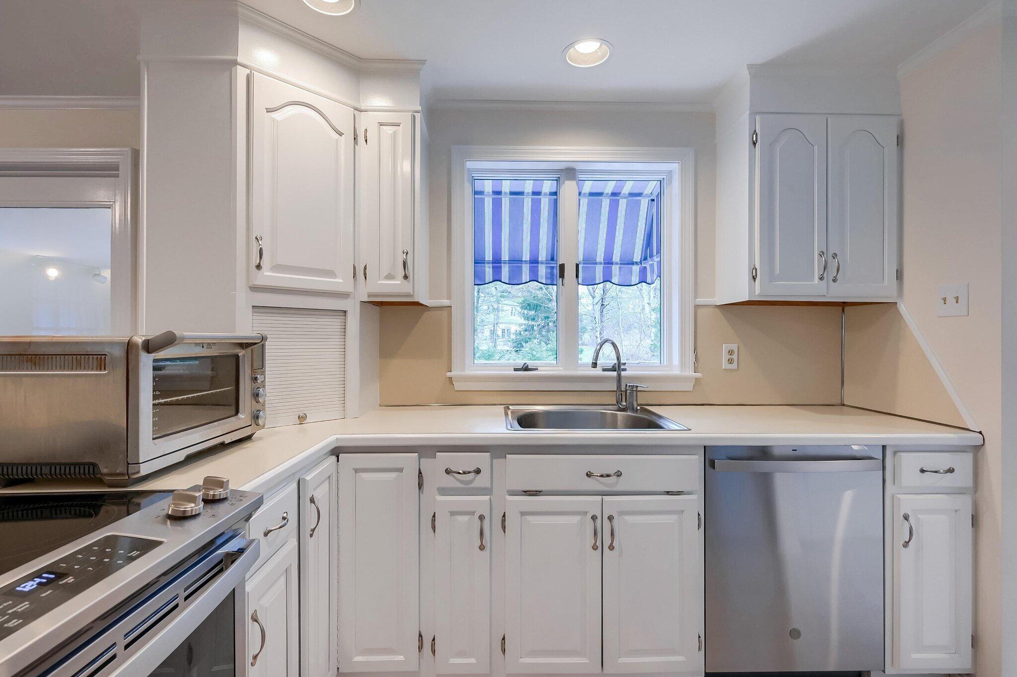 40 Barley Neck Road Orleans, MA 02653 - Photo 9 of 51 a kitchen with granite countertop a sink cabinets stainless steel appliances and a window