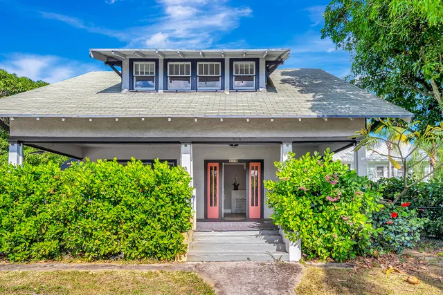 front view of a house with potted plants