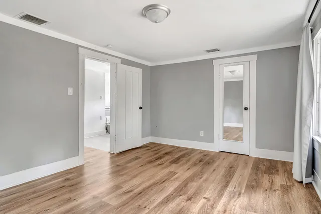 wooden floor in an empty room with a window