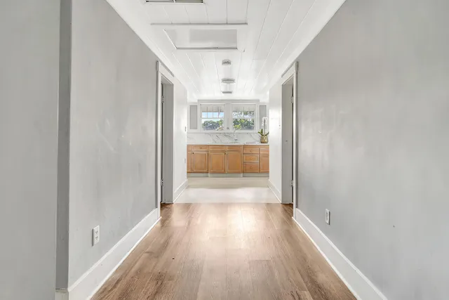 a view of hallway with wooden floor
