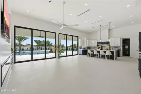 a kitchen with a table chairs refrigerator and microwave