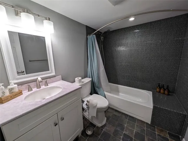 a bathroom with a sink a toilet and bathtub